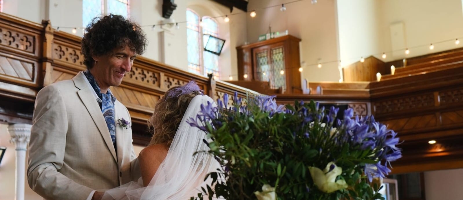 Dennis Edited Groom looking lovingly at bride at alter