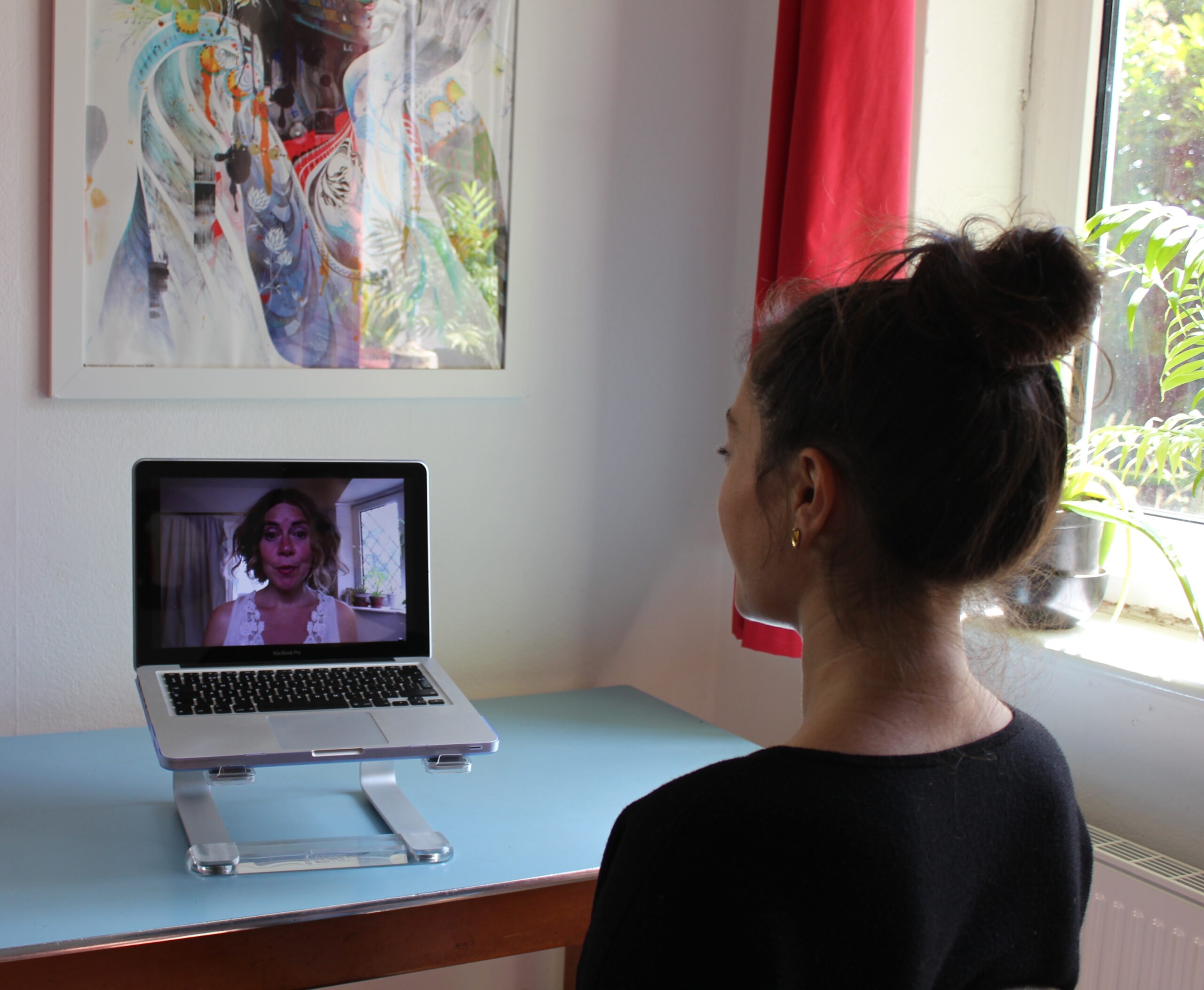 Woman facing laptop in an online session with Nicola